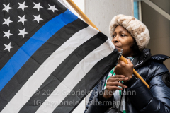 A woman holds up a  blue-line flag during the funeral service of NYPD Officer Wilbert Mora at St. Patrick’s Cathedral in New York, New York, on Feb. 2,  2022.  (Photo by Gabriele Holtermann/Sipa USA)
