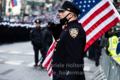 An NYPD officer stands in salute of his fallen colleague, NYPD Officer Wilbert Mora after his funeral service at St. Patrick’s Cathedral in New York, New York, on Feb. 2,  2022.  (Photo by Gabriele Holtermann/Sipa USA)