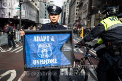 An NYPD officer holds up a sign after the funeral of fallen NYPD Officer Wilbert Mora at St.Patrick's Cathedral  in New York, New York, on Feb. 2, 2022. (Photo by Gabriele Holtermann/Sipa USA)