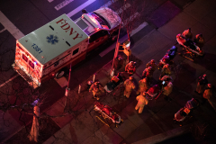 EMTs administer oxygen and check vitals on  two residents of 75 Henry after they had been rescued from their fourth floor balcony.