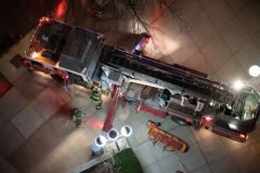 Fire fighters pack up their Ladder Truck after rescuing two residents from their fourth floor balcony at 75 Henry Street.