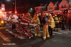 NEW YORK - Multi- Alarm residential fire guts home. Firefighters work to extinguish rapid moving fire. While Firefighters work on the fire Emergency Medical Service personnel wait to attend the injured.
