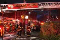 NEW YORK - Multi- Alarm residential fire guts home. Firefighters work to extinguish rapid moving fire. While Firefighters work on the fire Emergency Medical Service personnel wait to attend the injured.
