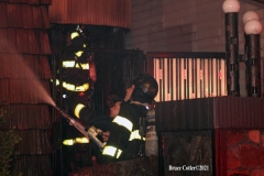 NEW YORK - Multi- Alarm residential fire guts home. Firefighters work to extinguish rapid moving fire. While Firefighters work on the fire Emergency Medical Service personnel wait to attend the injured.