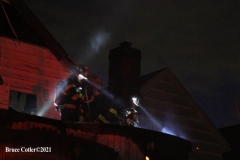 NEW YORK - Multi- Alarm residential fire guts home. Firefighters work to extinguish rapid moving fire. While Firefighters work on the fire Emergency Medical Service personnel wait to attend the injured.