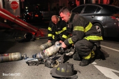 NEW YORK - Multi- Alarm residential fire guts home. Firefighters work to extinguish rapid moving fire. While Firefighters work on the fire Emergency Medical Service personnel wait to attend the injured.