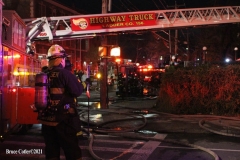 NEW YORK - Multi- Alarm residential fire guts home. Firefighters work to extinguish rapid moving fire. While Firefighters work on the fire Emergency Medical Service personnel wait to attend the injured.