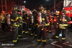NEW YORK - Multi- Alarm residential fire guts home. Firefighters work to extinguish rapid moving fire. While Firefighters work on the fire Emergency Medical Service personnel wait to attend the injured.