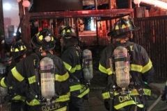 NEW YORK - Multi- Alarm residential fire guts home. Firefighters work to extinguish rapid moving fire. While Firefighters work on the fire Emergency Medical Service personnel wait to attend the injured.