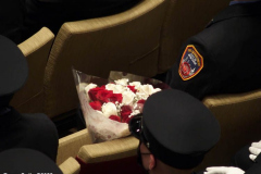 March 8, 2022  New York, 
Fire Department of The City of New York presents a Probationary Firefighter Graduation Ceremony at the Christian Cultural Center. 
.Flowers were placed where Probationary  firefighter Vincent Malveaux would have been seated. He died during a training exercise.