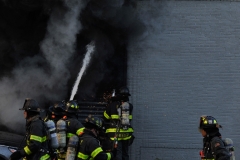 Firefighters work to put out a fast moving fire at Logan's Bus Company on Atlantic Avenue. (Photo by Lloyd Mitchell)