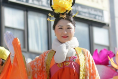 A person in traditional dress and costume waves from a parade float in celebration of the Lunar New Year during the annual Flushing Lunar New Year Parade in Flushing NY on February 5, 2022. This year is celebrated as the year of the Tiger. (Photo by Andrew Schwartz)