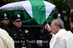 A funeral was held for retired deputy chief Charles “Chuckly” Scholl, a lifelong Brooklyn resident and former commander in Brooklyn South. Funeral was held at St. Mary Star of the Sea in his neighborhood of Cobble Hill, Brooklyn. Coffin is blessed by priest. (Photos by Todd Maisel)