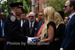 A funeral was held for retired deputy chief Charles “Chuckly” Scholl, a lifelong Brooklyn resident and former commander in Brooklyn South. Funeral was held at St. Mary Star of the Sea in his neighborhood of Cobble Hill, Brooklyn. Chief of Brooklyn South Michael Kemper presents flag to Scholl’s daughter Amanda. (Photos by Todd Maisel)