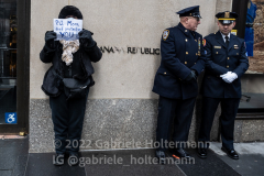 A woman holds up a sign during the funeral service of NYPD Officer Wilbert Mora at St. Patrick’s Cathedral in New York, New York, on Feb. 2,  2022.  (Photo by Gabriele Holtermann/Sipa USA)