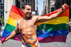 A man with a rainbow flag at the New York City Pride March.