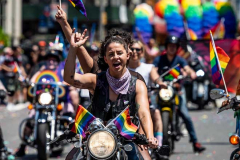 A woman on a motorcycle at the New York City Pride March.