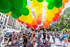 People marching under balloons at the New York City Pride March.
