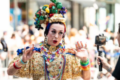 A woman being interviewed while marching in the New York City Pride March.