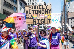 A person carrying a sign saying "Bodily autonomy is a human right" at the New York City Pride March.
