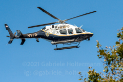 An NYPD helicopter conducts a fly-over at the inaugural flag football tournament in memory of Det. Keith Williams. (Photo by Gabriele Holtermann)