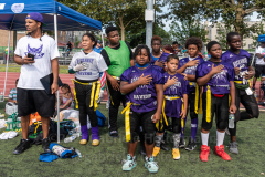 Players of the Rockaway Ravens listen to the Pledge of Allegiance at the inaugural flag football tournament in memory of Det. Keith Williams. (Photo by Gabriele Holtermann)
