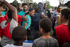 NYPD Chief Jeffrey Maddrey embraces MVP Anthony Childs during the trophy ceremony of the inaugural flag footbal tournament in memory of fallen Det. Keith Williams. (Photo by Gabriele Holtermann)