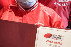 Guardian Angels from all over 5 Boroughs schlepped through the snow and met in Washington Heights at the Angelica’s Uptown Cafe on W 187th Street to celebrate the 43rd Anniversary of the beloved and renowned establishment begun by Curtis Sliwa in the Bronx with just 13 kids in 1979. 
Several hundred came to show their respects and to celebrate where Officials and Heads of the Districts and Chapters spoke and gave out awards to the outstanding representatives and Guardians of 2021.
“We are no different from one another. Guardian Angels have given people a purpose, a duty of providing safety and security amongst their communities,” was exclaimed. 
“Crime has gone up and recruitment is harder,” were other sentiments shared on not only local but Global as well. The Guardian Angels spans now 13 countries across the Globe with Japan holding 21 chapters alone. International presence was provided via ZOOM during the event.
Many people who have been involved in Guardian Angels have moved onto other areas of security jobs and the security sectors.
Sliwa encouraged the importance of keeping streets safe especially in times of uncertainty and the power of community and most of all harmony amongst all.
Manhattan, NYC. February 13, 2022. (C) Bianca Otero