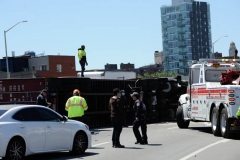 Big rig towers work to secure a tractor trailer that flipped over and sent 100's of gallons spilling onto the Brooklyn- Queens Expressway at Flushing Avenue.