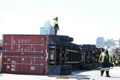 Big rig towers work to secure a tractor trailer that flipped over and sent 100's of gallons spilling onto the Brooklyn- Queens Expressway at Flushing Avenue.