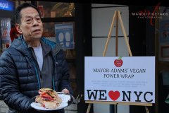 Rupert Jee holding Mayor Adam’s Vegan Power Wrap outside Hello Deli celebrating the 30th anniversary on Jan 31 2022.