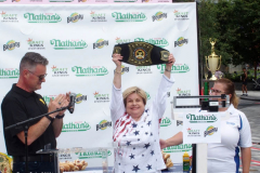 Official Weigh - in Ceremony for Nathan's Famous Fourth of July Hot Dog Eating Contest Joey Chestnut and Michele Lesco are the favorites to win the contest. Joey Chestnut is going for his 14th win.  1984 winner  Birgit Felden
9.5 Hot Dogs