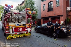Two NYPD officers of the 78th Precinct on the scene of downed trees on 7th Street in the Park Slope neighborhood of Brooklyn as FDNY firefighters of Engine 239/Ladder 122 clear the scene. (Photo by Gabriele Holtermann/Sipa USA)