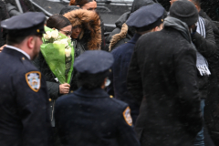 A woman carries in flowers to the funeral of NYPD Officer Jason Rivera at St. Patricks Cathedral on Friday, January 28,2022. Rivera was shot and killed responding to a domestic violence incident at 119 West 135 Street in Harlem on January, 21,2022.