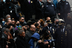 The family of slain officer Jason Rivera becomes emotional during his funeral.