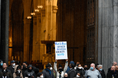 A woman holds up a sign during NYPD Officer Jason Rivera's funeral.
