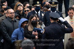 An NYPD officer salutes Dominique Luzuriaga, the widow of NYPD Officer Jason Rivera after his funeral service at St. Patrick’s Cathedral in New York, New York, on Jan. 28, 2022.  (Photo by Gabriele Holtermann/Sipa USA)