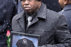 Calvin Hunt holds a picture of fallen NYPD Officer Jason Rivera as police officers from around the country gather at St. Patrick's Cathedral to attend his funeral on January 28, 2022 in New York City. The 22-year-old NYPD officer was shot and killed on January 21 in Harlem while responding to a domestic disturbance call. Rivera's partner, Officer Wilbert Mora, also died from injuries suffered in the shooting.