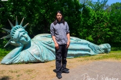Artist Zaq Landsberg's sculpture entitled "Reclining Liberty" inside Morningside Park in New York City on 21 May 2021. The sculpture was created by Landsberg and features the Statue of Liberty posed on her side with her head propped up by her hand. The 25 foot long sculpture  is covered in oxidized copper paint and features a steel crown and was created using wood, foam and plaster resin.