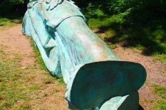Artist Zaq Landsberg's sculpture entitled "Reclining Liberty" inside Morningside Park in New York City .The sculpture was created by Landsberg and features the Statue of Liberty posed on her side with her head propped up by her hand. The 25 foot long sculpture  is covered in oxidized copper paint and features a steel crown and was created using wood, foam and plaster resin.