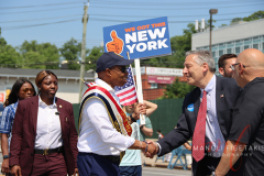 Mayor Adams shaking hands with Jon Kaiman marching in Little Neck Memorial Day Parade.