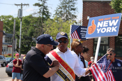 Paul Vallone shaking hands with Mayor Adams marching in Little Neck Memorial Day Parade.