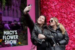 Visitors pose with the multitude of flowers both inside and outside the Macy's Department Store during the annual Macy's Flower Show on 34th Street and Broadway in New York City on March 27, 2022. (Photo by Andrew Schwartz)