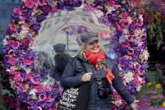 Visitors pose with the multitude of flowers both inside and outside the Macy's Department Store during the annual Macy's Flower Show on 34th Street and Broadway in New York City on March 27, 2022. (Photo by Andrew Schwartz)