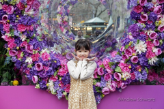 Visitors pose with the multitude of flowers both inside and outside the Macy's Department Store during the annual Macy's Flower Show on 34th Street and Broadway in New York City on March 27, 2022. (Photo by Andrew Schwartz)