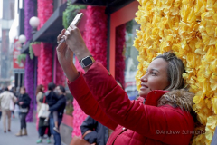 Visitors pose with the multitude of flowers both inside and outside the Macy's Department Store during the annual Macy's Flower Show on 34th Street and Broadway in New York City on March 27, 2022. (Photo by Andrew Schwartz)