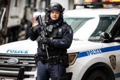 Police Officer Wilbert Mora was laid to rest 2/2/22 after being posthumously promoted to Detective First Grade, and eulogized at St. Patrick’s Cathedral. Thousands of police from all parts of the country lined Fifth Ave. as the procession carrying Detective Mora passed.  Mora was gunned down along with his partner Jason Rivera, who passed away a few days earlier. Here an officer stands guard by St. Pat’s.