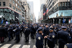 Police Officer Wilbert Mora was laid to rest 2/2/22 after being posthumously promoted to Detective First Grade, and eulogized at St. Patrick’s Cathedral. Thousands of police from all parts of the country lined Fifth Ave. as the procession carrying Detective Mora passed.  Mora was gunned down along with his partner Jason Rivera, who passed away a few days earlier. Police wait and then line up to salute as the funeral procession passes.