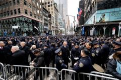 Police Officer Wilbert Mora was laid to rest 2/2/22 after being posthumously promoted to Detective First Grade, and eulogized at St. Patrick’s Cathedral. Thousands of police from all parts of the country lined Fifth Ave. as the procession carrying Detective Mora passed.  Mora was gunned down along with his partner Jason Rivera, who passed away a few days earlier. Police wait and then line up to salute as the funeral procession passes.