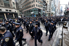 Police Officer Wilbert Mora was laid to rest 2/2/22 after being posthumously promoted to Detective First Grade, and eulogized at St. Patrick’s Cathedral. Thousands of police from all parts of the country lined Fifth Ave. as the procession carrying Detective Mora passed.  Mora was gunned down along with his partner Jason Rivera, who passed away a few days earlier. Police wait and then line up to salute as the funeral procession passes.